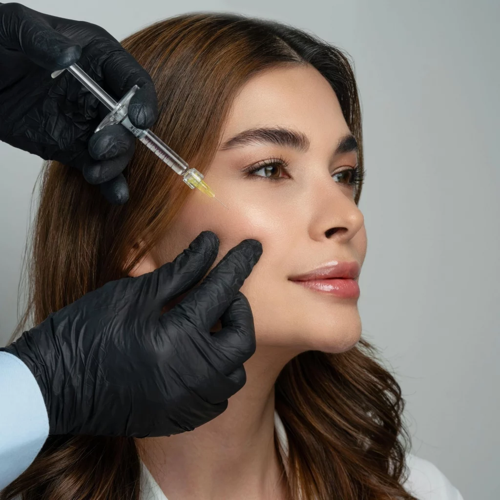 Woman receiving dermal filler injection in cheek at Etica Clinic London