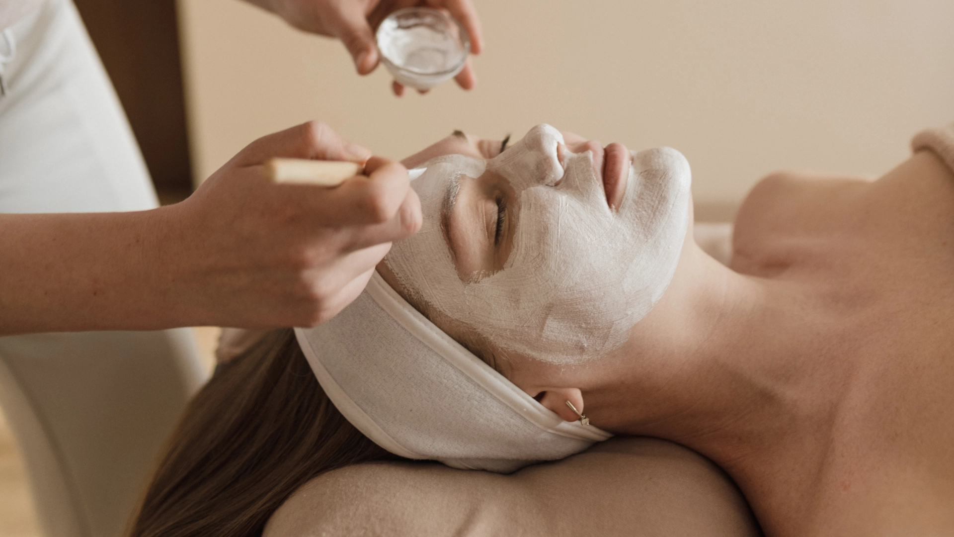 Client enjoying a relaxing facial mask treatment at Etica Beauty Clinic