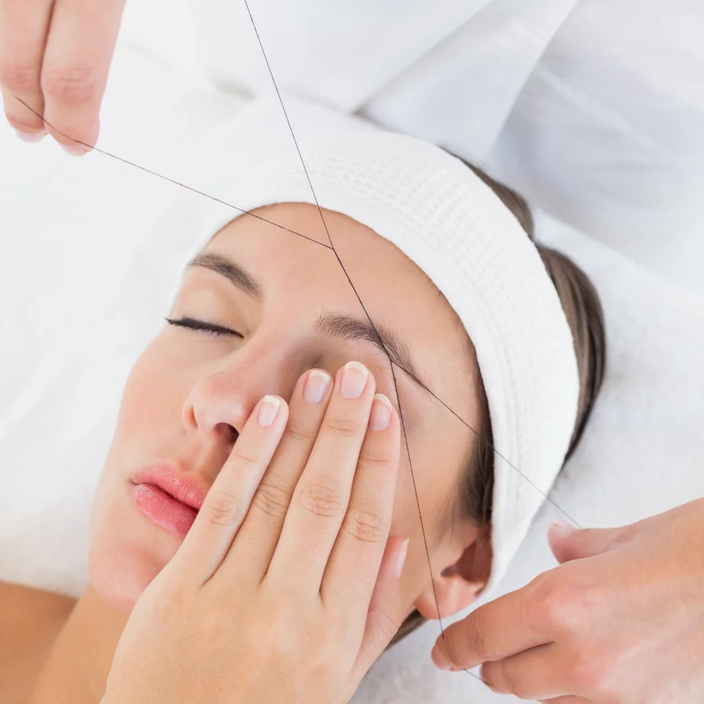 Woman receiving professional eyebrow threading at Etica Beauty