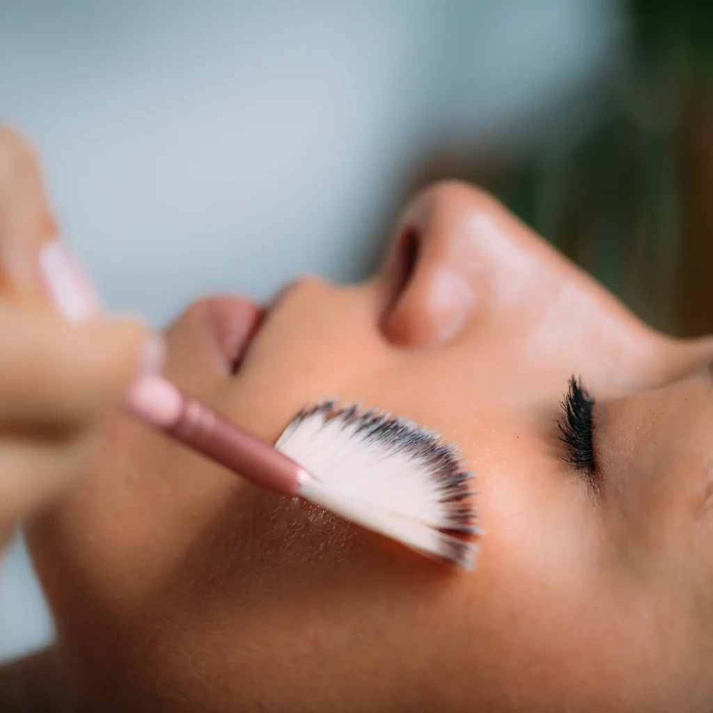 Close-up of a mesopeel being applied to the cheek during a facial treatment