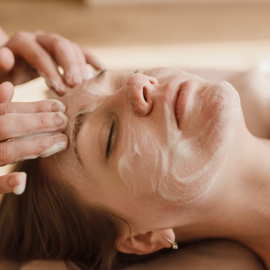 Gentle cleanser being massaged into the skin during a signature facial at Etica Clinic